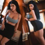 Split image of a woman with curly hair in a blue crop top and black mini skirt posing by wooden walls; left leaning on a door frame, right standing with hand on a wall.