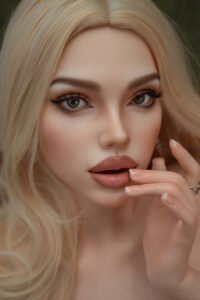 Close-up of a blonde woman with smoky eyes, long lashes, and pink glossy lips, fingers near her mouth with manicured nails.